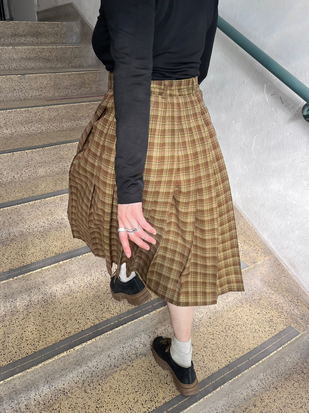 Someone walking up stairs in Pia skirt in Woodland Plaid